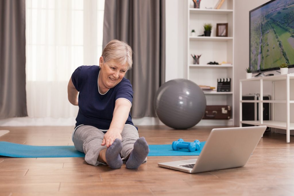 Cheerful old woman doing sport