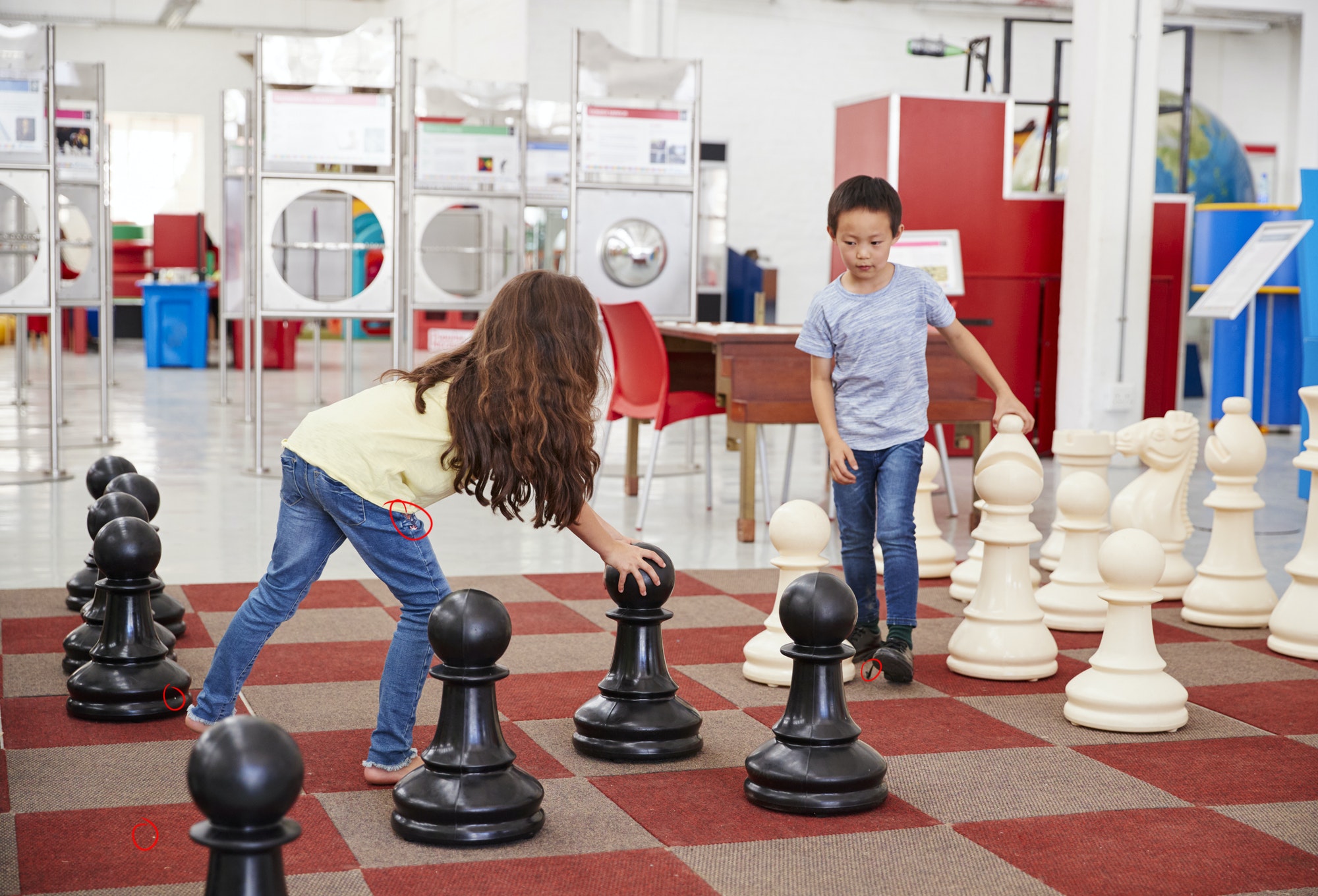 Schoolchildren playing giant chess at a science centre