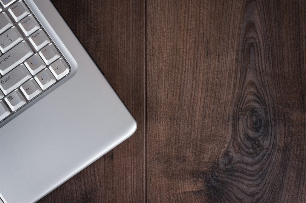 Laptop On Brown Wooden Background